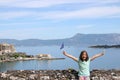 Little girl with hands up and greek flag at Corfu fortress Greece Royalty Free Stock Photo