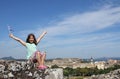 Little girl with hands up and greek flag at Corfu fortress