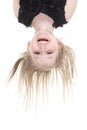 Happy little girl hanging upside down isolated on Royalty Free Stock Photo