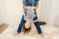 Happy little girl hanging upside down in mother or sister hands Royalty Free Stock Photo