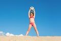 Happy little girl has fun playing on the beach with a ball on a sunny summer day. Concept about sports and active games in summer Royalty Free Stock Photo