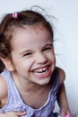 Happy little girl having fun playing with toy guitar or ukulele. Royalty Free Stock Photo