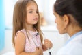 Happy little girl at health exam at doctor office. Medicine and health care concept Royalty Free Stock Photo