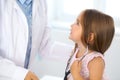 Happy little girl at health exam at doctor office. Medicine and health care concept Royalty Free Stock Photo