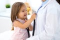 Happy little girl at health exam at doctor office. Medicine and health care concept Royalty Free Stock Photo