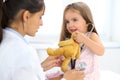 Happy little girl at health exam at doctor office. Medicine and health care concept Royalty Free Stock Photo