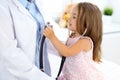 Happy little girl at health exam at doctor office. Medicine and health care concept Royalty Free Stock Photo