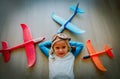 Happy little girl with helmet and glasses play with toy planes Royalty Free Stock Photo