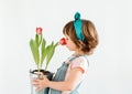 Happy Little girl is holdinf red tulips against a white background. Spring and Easter concept Royalty Free Stock Photo