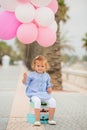 Happy little girl holding a bunch of balloons Royalty Free Stock Photo