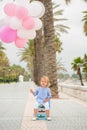 Happy little girl holding a bunch of balloons Royalty Free Stock Photo