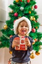 Happy Little Girl Holding a Christmas Gift Royalty Free Stock Photo