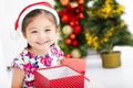 Happy little girl holding Christmas gift Royalty Free Stock Photo