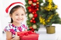 Happy little girl holding Christmas gift Royalty Free Stock Photo