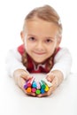 Happy little girl holding colorful modelling clay bars