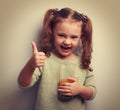 Happy little girl holding glass of juice Royalty Free Stock Photo