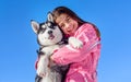 Happy little girl holding her puppy dog husky Royalty Free Stock Photo