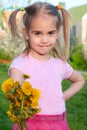 Happy little girl holding out flowers Royalty Free Stock Photo