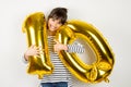 Ten birthday party girl with golden balloons