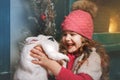 Happy little girl holding a white rabbit in her arms Royalty Free Stock Photo