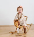 Happy little girl and horse - rocking chair Royalty Free Stock Photo