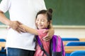 Happy little Girl hugging her father in classroom Royalty Free Stock Photo