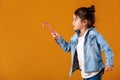 Happy little girl in jeans clothes holding lollipop Royalty Free Stock Photo