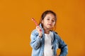 Happy little girl in jeans clothes holding lollipop Royalty Free Stock Photo