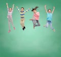 Happy little girl jumping in air over school board Royalty Free Stock Photo