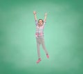 Happy little girl jumping in air over school board Royalty Free Stock Photo