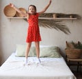 Happy little girl jumping on bed, singing a song Royalty Free Stock Photo