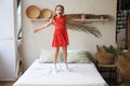 Happy little girl jumping on bed, singing a song Royalty Free Stock Photo