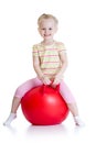 Happy little girl jumping on bouncing ball Royalty Free Stock Photo