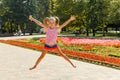 Happy little girl jumping in the park. little girl eating ice cream and having fun in the city Royalty Free Stock Photo