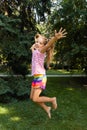 Happy little girl jumping in the park. little girl eating ice cream and having fun in the city Royalty Free Stock Photo