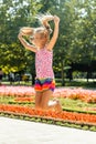Happy little girl jumping in the park. little girl eating ice cream and having fun in the city Royalty Free Stock Photo