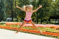 Happy little girl jumping in the park. little girl eating ice cream and having fun in the city Royalty Free Stock Photo