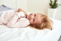 Happy little girl kid relax on bed at home Royalty Free Stock Photo