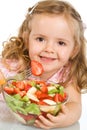 Happy little girl with a large bowl of fruit salad