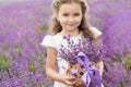 Happy little girl in lavender field with basket Royalty Free Stock Photo