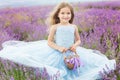 Happy little girl in lavender field with basket Royalty Free Stock Photo