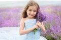 Happy little girl in lavender field with bouquet Royalty Free Stock Photo