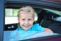 Happy little girl looking out of a car window Royalty Free Stock Photo