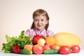 Happy little girl and a lot of fruit and vegetables.