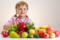 Happy little girl and a lot of fruit and vegetables.