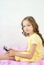 Happy little girl lying on bed with tablet computer Royalty Free Stock Photo