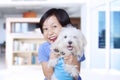 Happy little girl and maltese dog at home Royalty Free Stock Photo