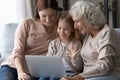 Happy little girl with mother and grandmother using laptop together Royalty Free Stock Photo