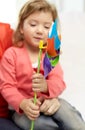 Happy little girl with mother holding pinwheel toy Royalty Free Stock Photo