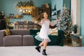 Happy little girl near the Christmas tree waiting for Santa Claus Royalty Free Stock Photo